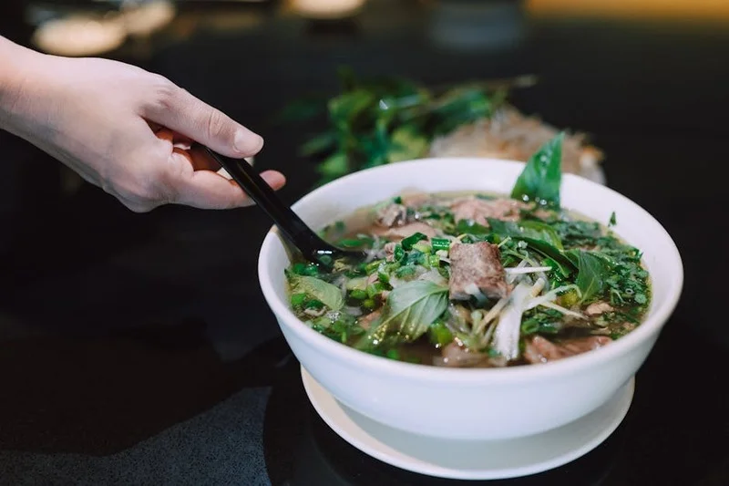 Authentic Vietnamese Pho noodle soup with fresh garnishes