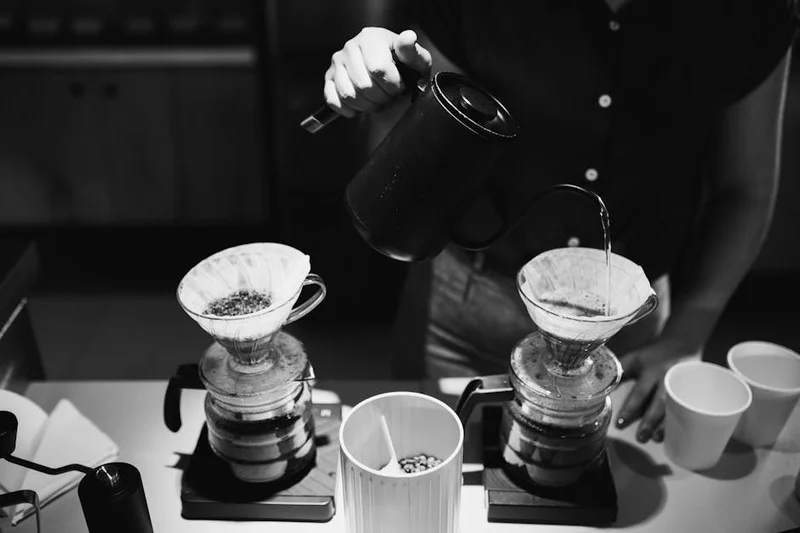 Barista preparing pour-over coffee in a modern cafe
