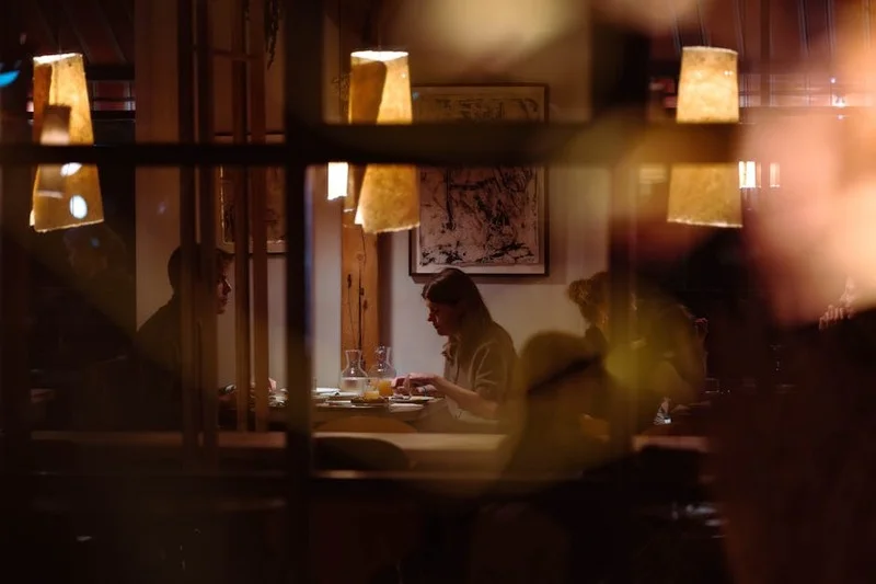 Guests enjoying a pleasant meal in a warm, inviting restaurant atmosphere