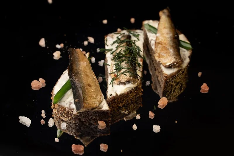 Artfully plated vegan smoked carrot lox with fresh dill cream and toasted rye bread