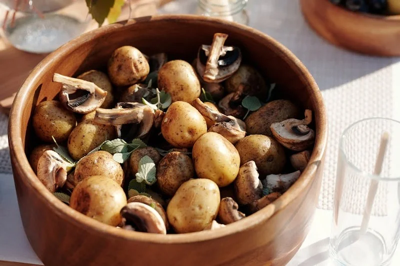 Rich vegan mushroom coq au vin served with smooth mashed potatoes and vibrant baby carrots